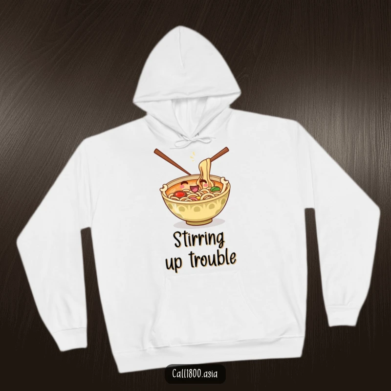 Funny hoodie featuring a playful ramen bowl with chopsticks as arms stirring its noodles, offering cozy cartoon comfort.